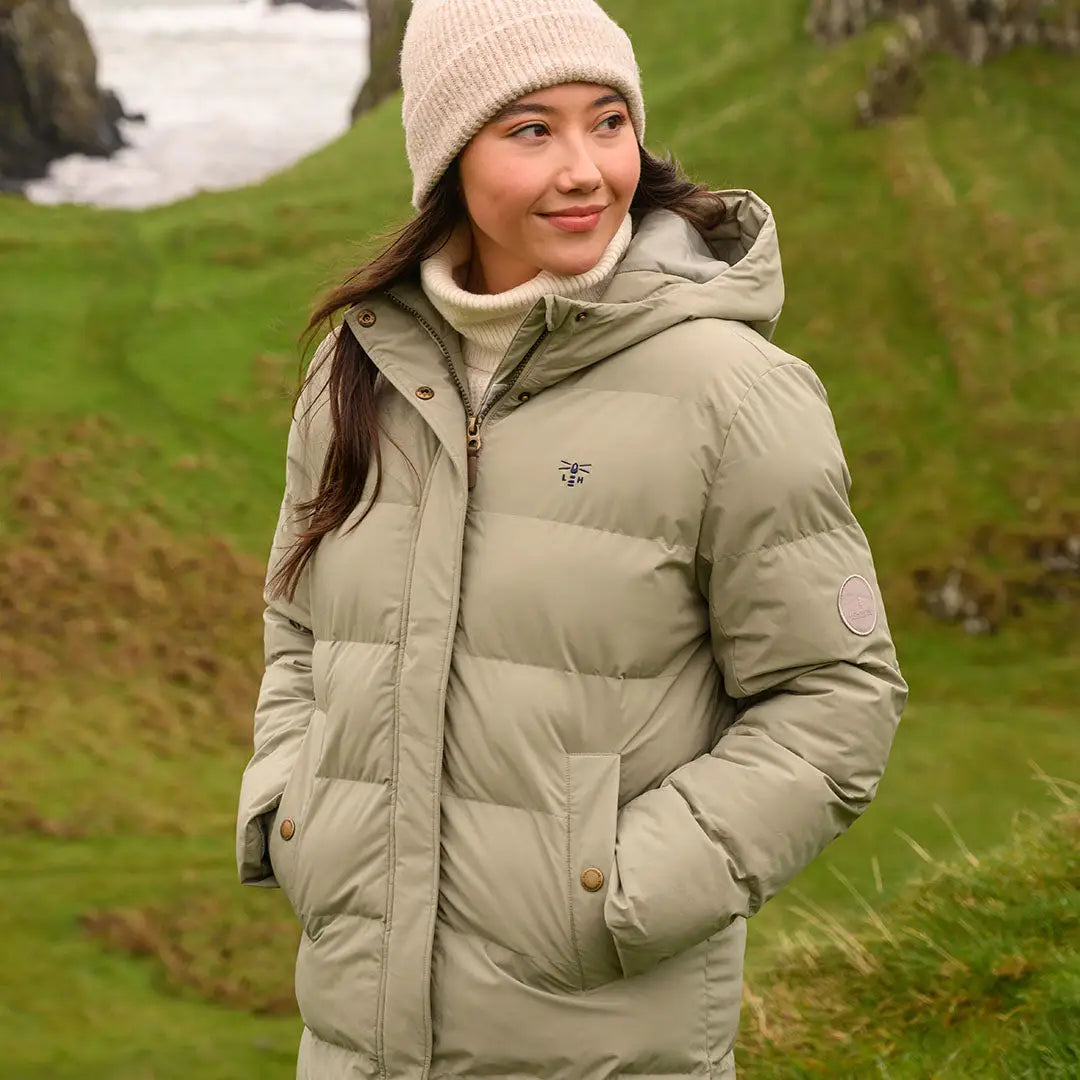 Woman in beige Lighthouse Savannah Coat with hood and ribbed beanie for cozy style