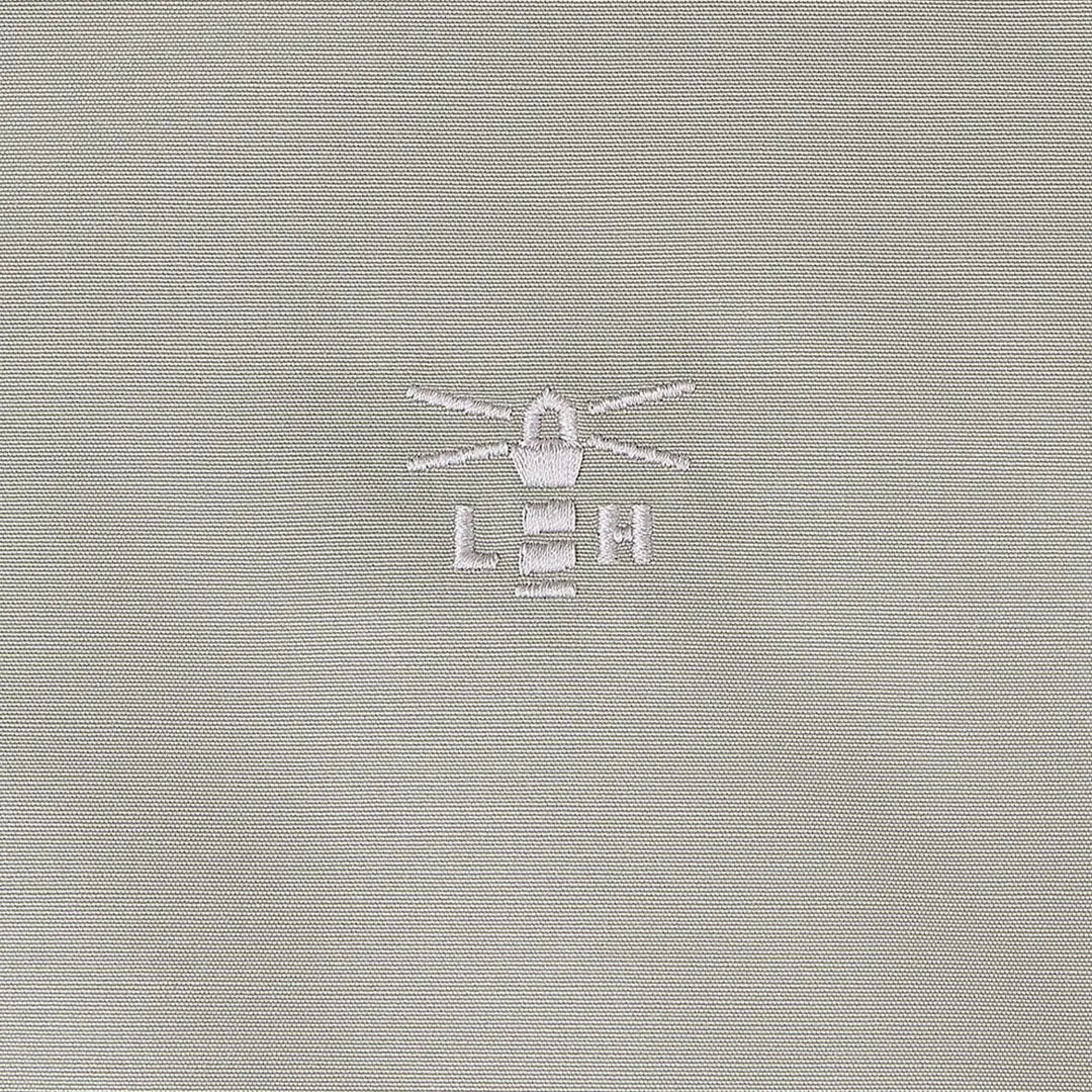 Light gray fabric with embroidered lighthouse logo on Lighthouse Scarlet Ladies Coat for outdoors