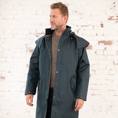 Long teal raincoat from Lighthouse Stockman, perfect for a cold winter’s day