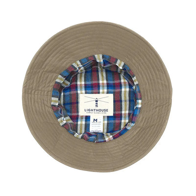 Beige bucket hat with plaid lining, perfect for the Lighthouse Storm Waterproof vibes