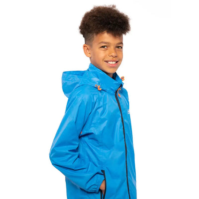 Smiling kid in bright blue Mac in a Sac Origin jacket, perfect for country clothing adventures
