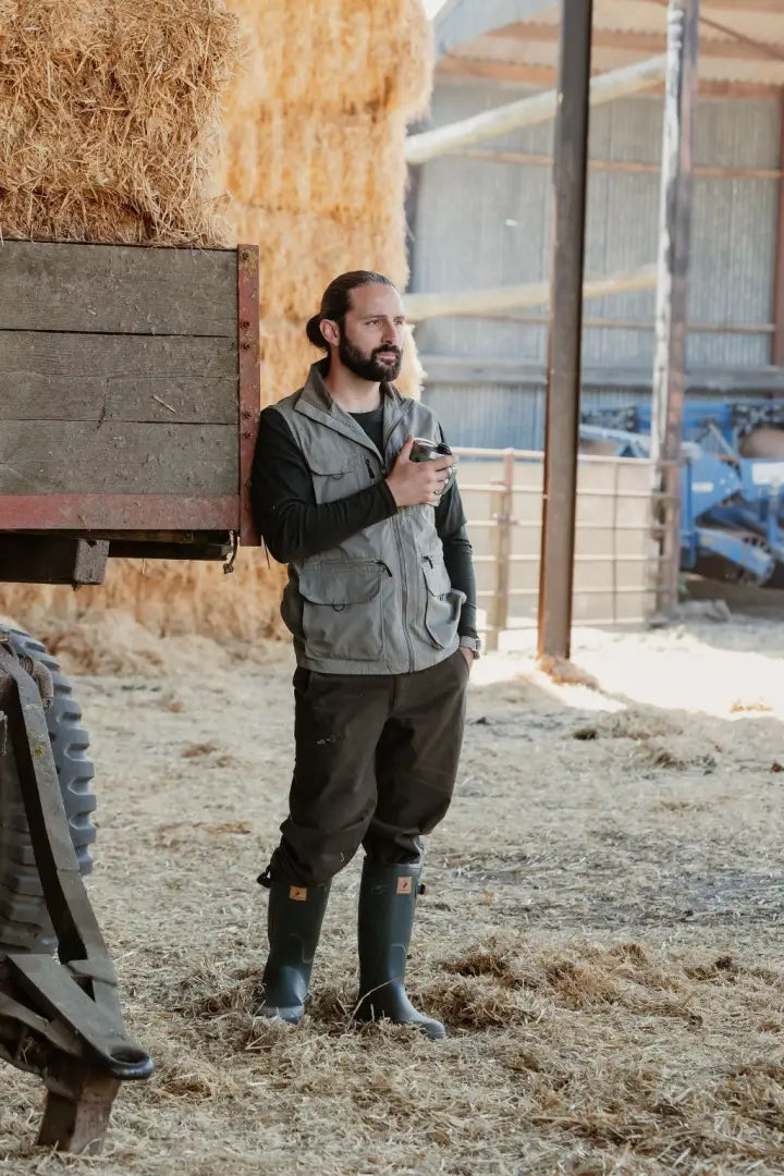 Bearded man in farm gear wearing New Forest Avon zip Wellington boots on the farm