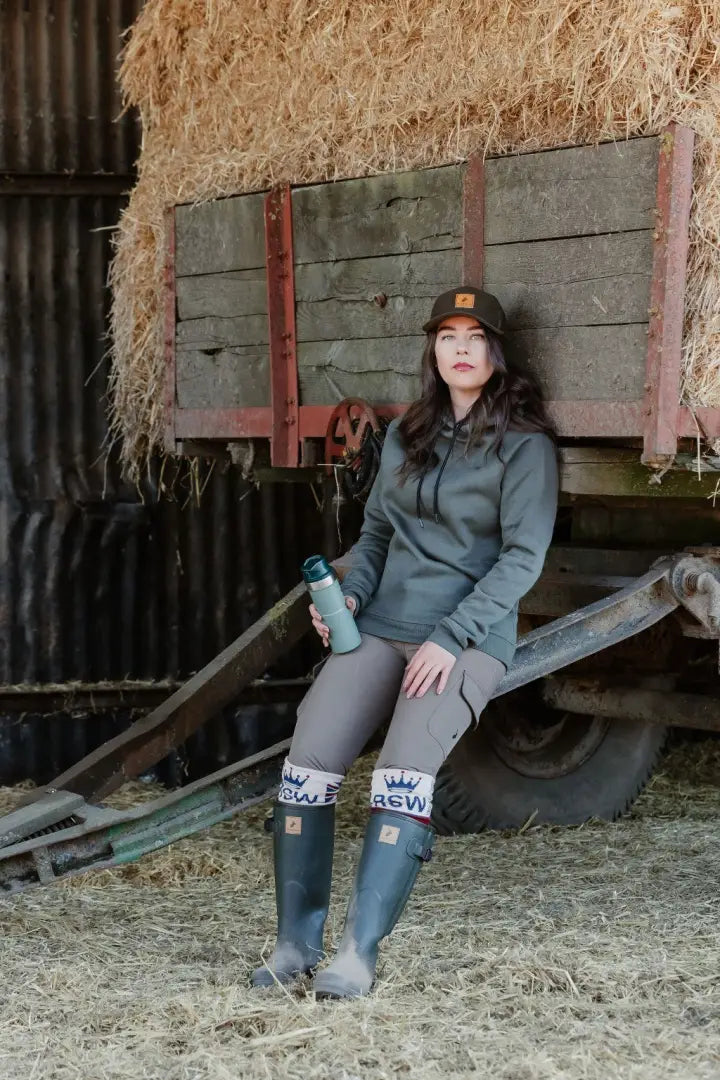 Woman in outdoor attire wearing New Forest Avon Zip Wellington Boots in forest setting