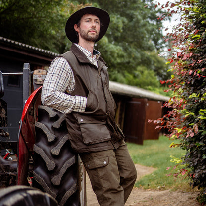 Man in outdoor attire wearing the New Forest Bushman Wax Gilet for adventure