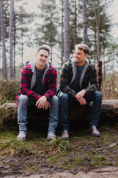 Two men in a green lumberjack shirt on a log, showcasing the Forest Canadian Sherpa style