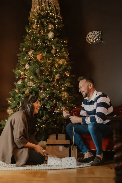 Festive couple unboxing gifts in New Forest Classic Stripe Rugby Shirt, perfect for holidays