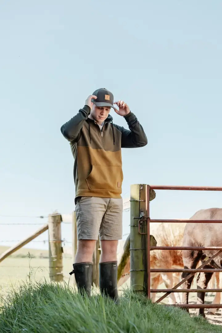 Man in outdoor attire wearing the New Forest Country Sport iconic trucker hat