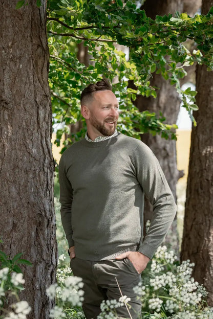 Man wearing New Forest Crew Neck Jumper in olive green, perfect for a forest crew look