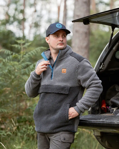 Man in a gray New Forest Fox Fibre Pile Fleece for cozy comfort