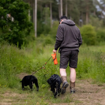 Man walking dogs wearing a Forest Heathland Hoodie in the scenic heathland area