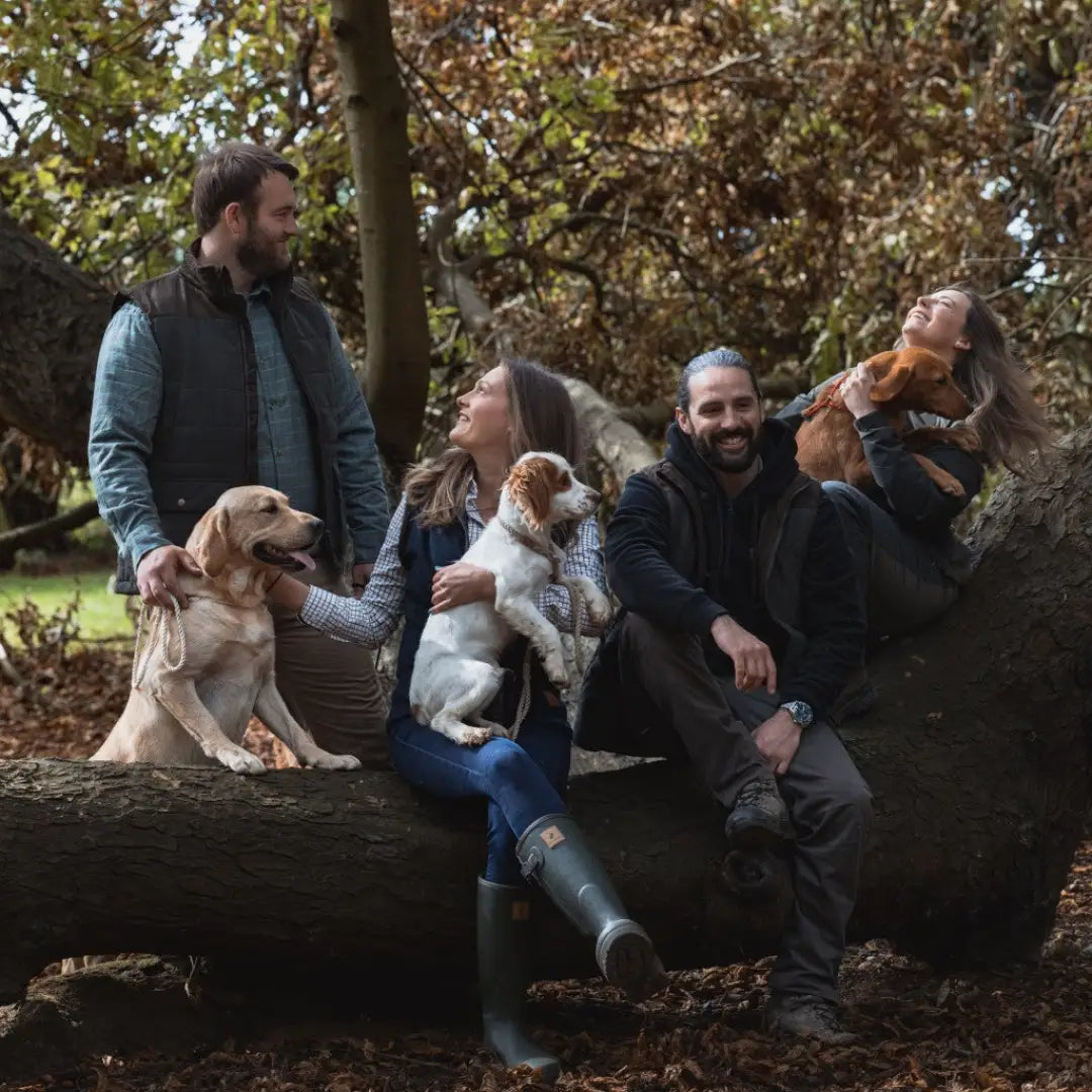 Group of friends and dogs in woods wearing the cozy forest heathland hoodie
