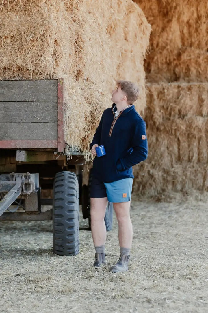 Man in Navy Knightwood Quarter Zip Fleece and shorts casual look