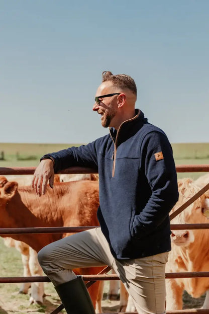 Man wearing a navy Knightwood Quarter Zip Fleece from New Forest Knightwood Quarter collection