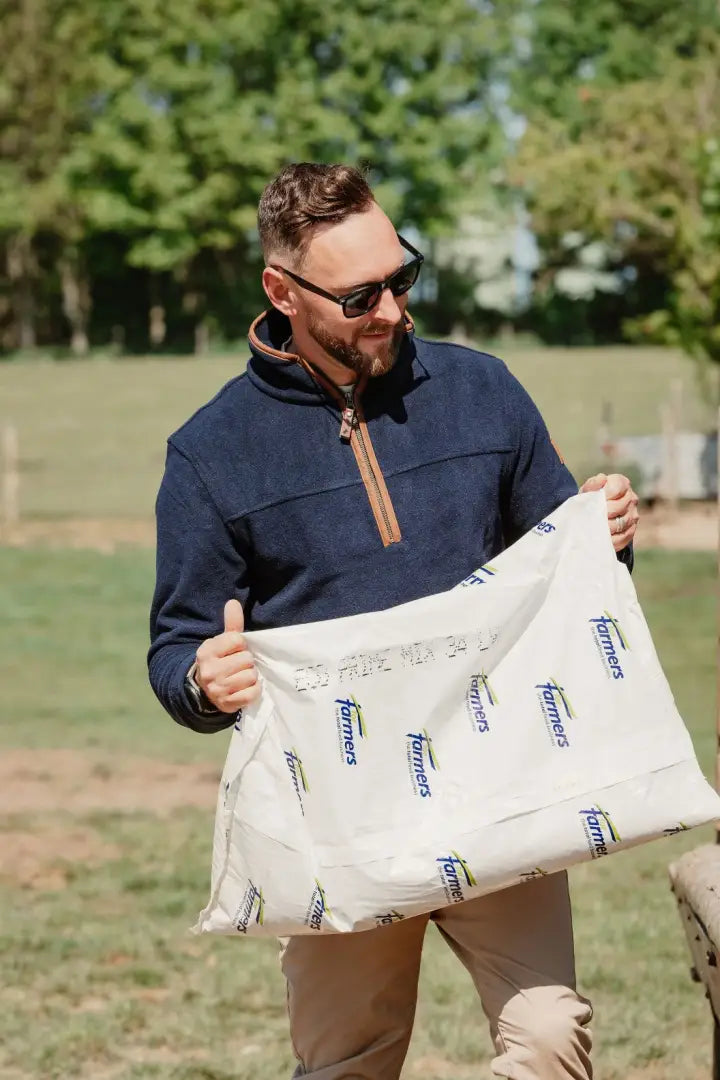 White bag with Farmers logo for New Forest Knightwood Quarter Zip Fleece product