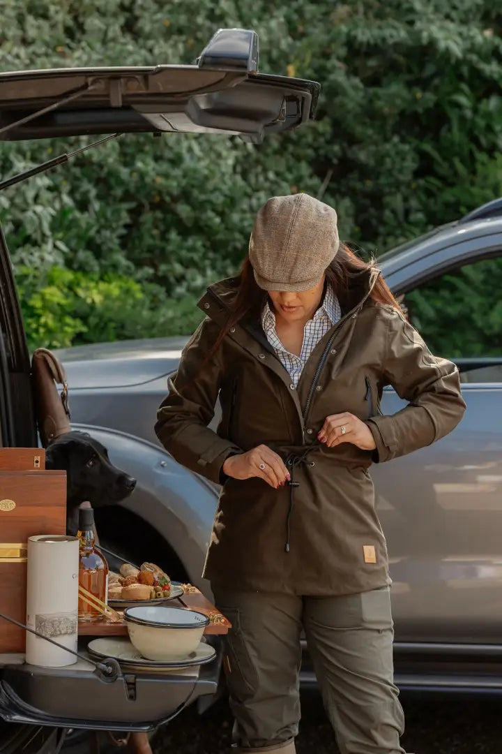 Woman adjusting her olive green New Forest Ladies Country Sport Smock outdoor jacket