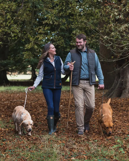 Couple walking dogs in woods wearing Forest Ladies Fleece Gilet for ladies fleece style