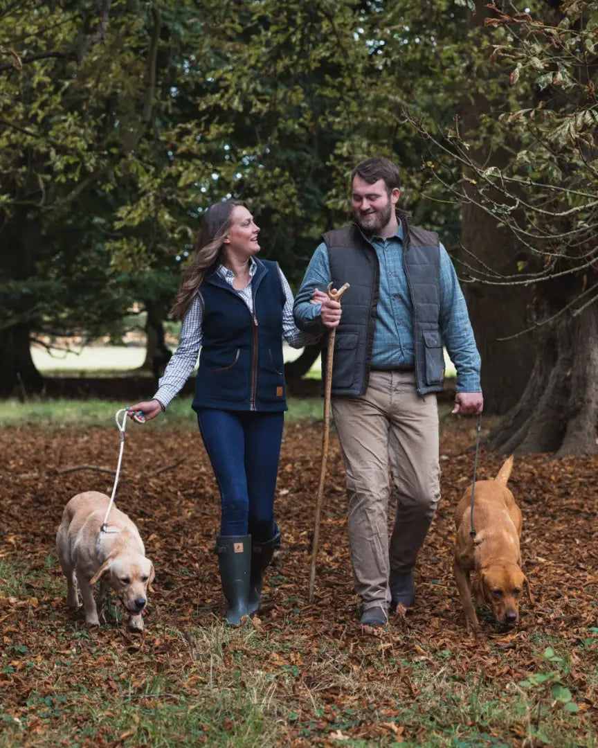 Couple walking dogs in woods wearing Forest Ladies Fleece Gilet for ladies fleece style
