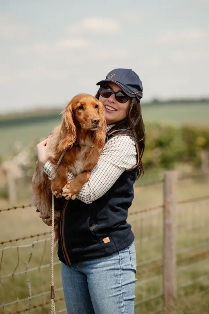 Woman holding a Cocker Spaniel in New Forest Ladies Knightwood Gilet, perfect for country outdoor hunting gear