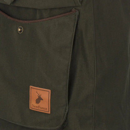 Green canvas pocket with brown trim on Forest Ladies Marsh jacket, ladies marsh gear