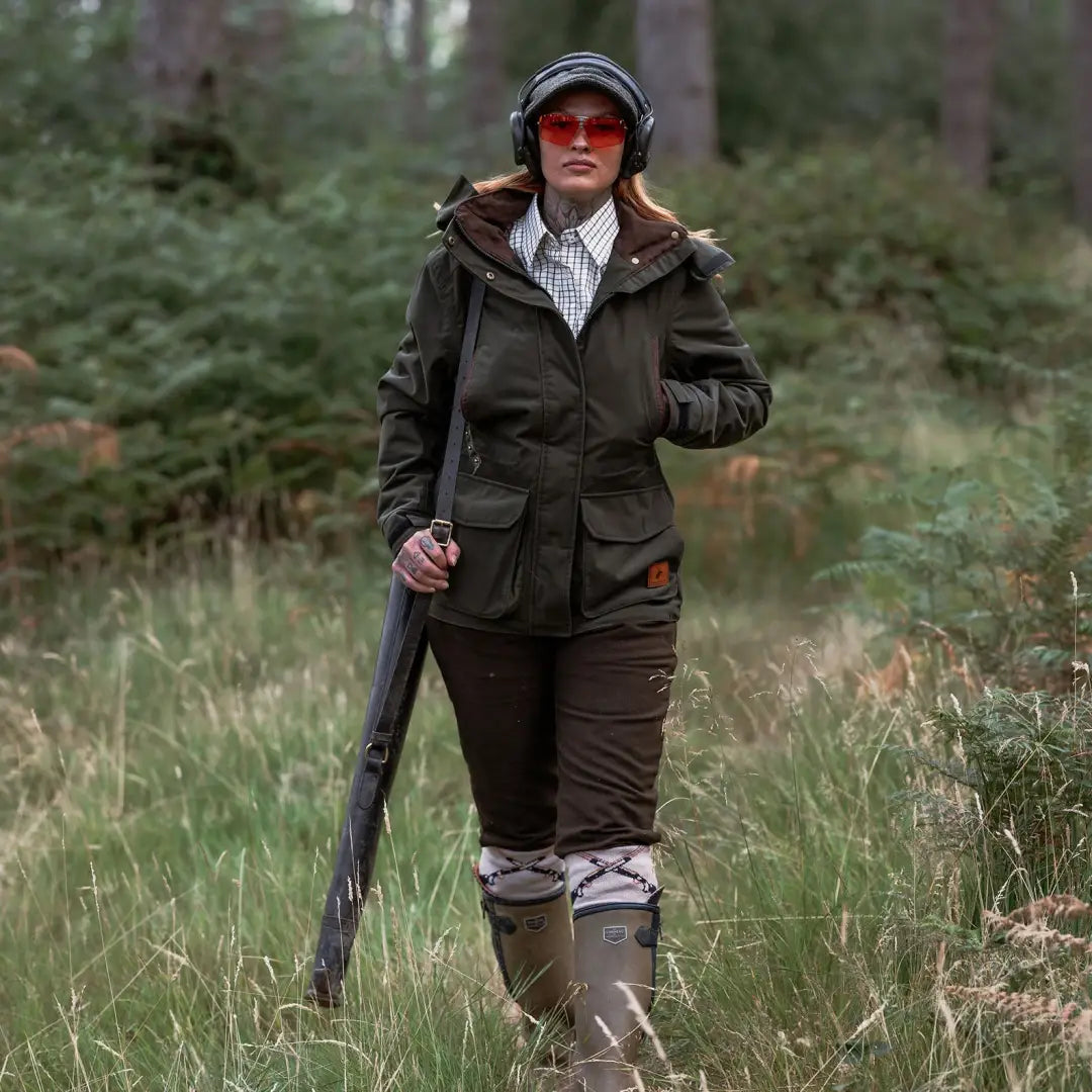 Hunter in forest ladies marsh jacket wearing outdoor gear perfect for adventures