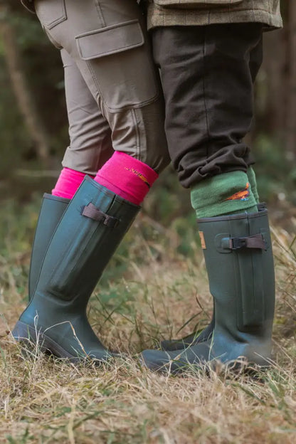 Two people in knee-high rubber boots with colorful socks wearing New Forest Ladies Outdoor Stretch Trousers