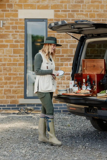Woman in New Forest Ladies Outdoor Stretch Trousers enjoying a tailgate picnic with drinks and snacks