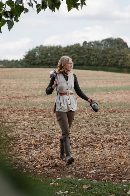 Forest ladies outdoor outfit with outdoor stretch trousers, vest, rifle, and boots