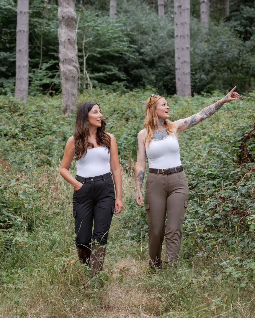 Two women in forest ladies outdoor stretch trousers enjoying nature outdoors