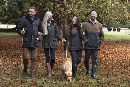 Four people and a dog walking outdoors in forest ladies robyn jacket style