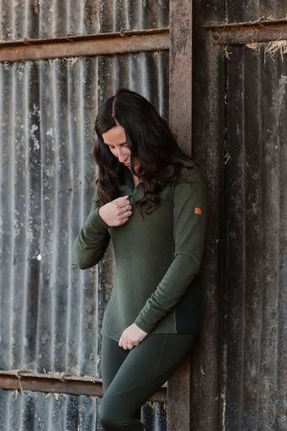 Woman in olive green athletic wear showcasing New Forest Ladies Trail Fleece on a forest trail