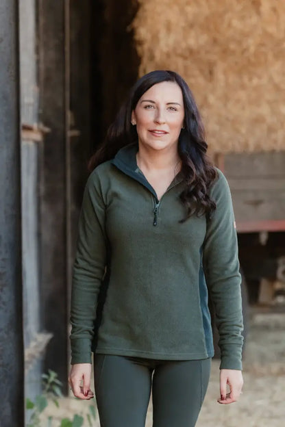 Woman in green forest trail fleece athletic wear ready for hiking or outdoor adventure