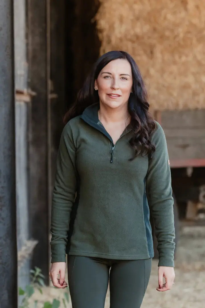Woman in green forest trail fleece athletic wear ready for hiking or outdoor adventure