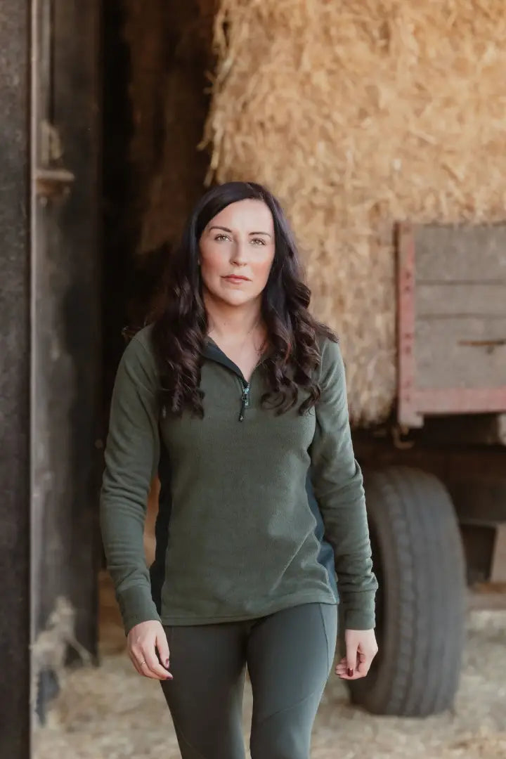 Woman in green athletic wear featuring New Forest Ladies Trail Fleece for forest trail hiking