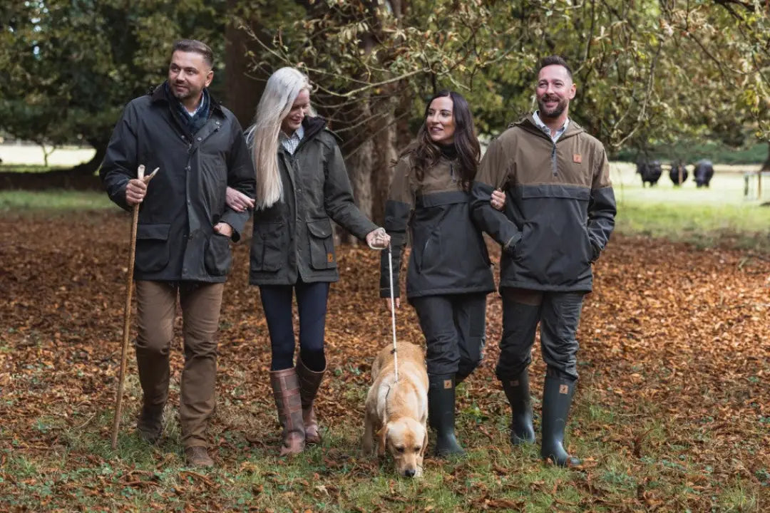 Four people and a dog walking outdoors in practical forest trek leggings