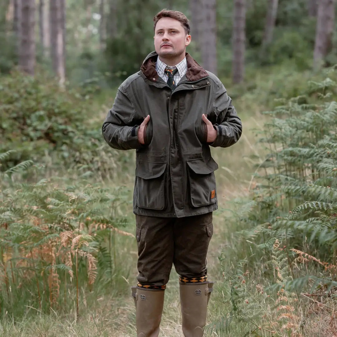 Man in outdoor hunting attire wearing the New Forest Marsh Jacket in the forest