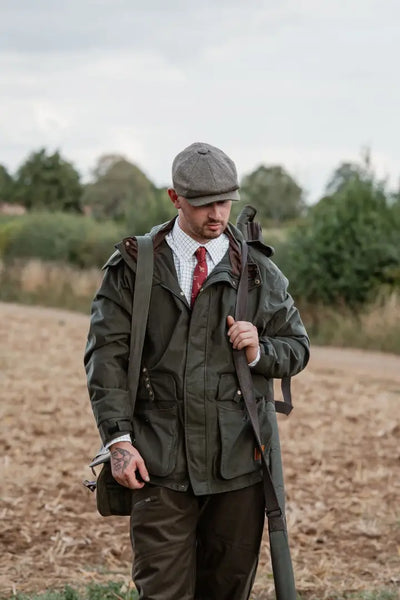 Man in green forest marsh jacket with rifle, perfect for outdoor hunting trips