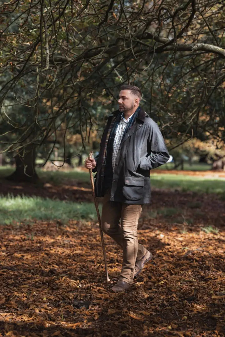 Man in dark jacket and tan pants holding a walking stick wearing New Forest Moleskin Jeans