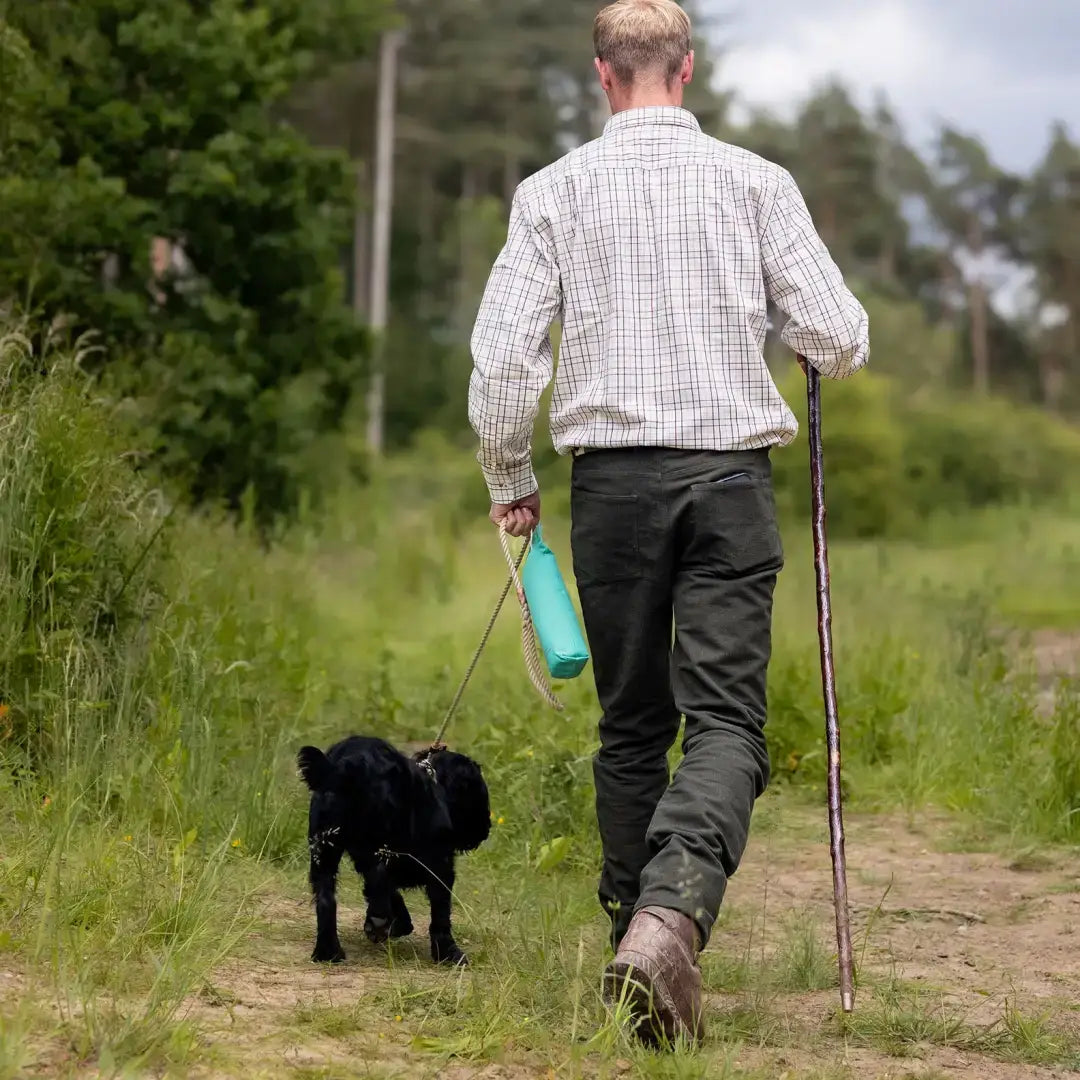 Man walking dog in forest moleskin jeans, perfect for outdoor adventures