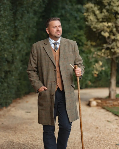 Men’s tweed overcoat with forest moleskin jeans, brown plaid pattern, walking stick