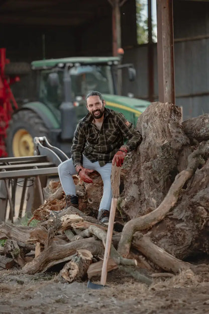 Bearded man with axe wearing New Forest Padded Shirt, expertly made padded shirt for outdoors
