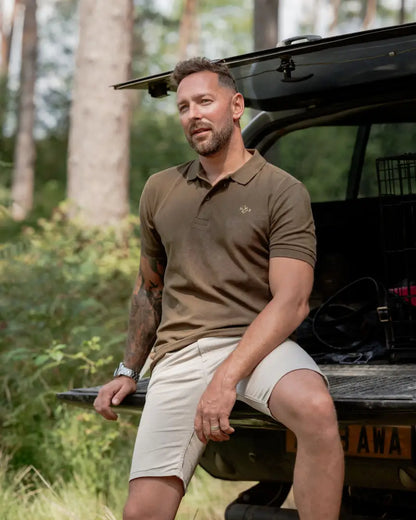 Man in New Forest Pique Polo Shirt wearing shorts, perfect forest pique polo style
