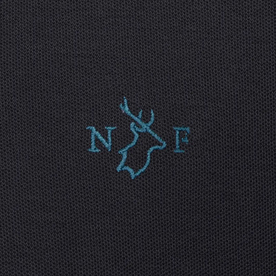Dark fabric with embroidered logo on New Forest Pique Polo Shirt for stylish comfort