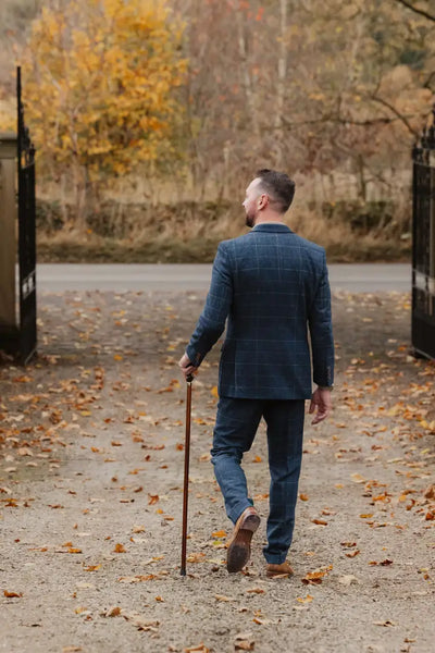 Man in blue suit with walking stick showcasing New Forest wool tweed blazer