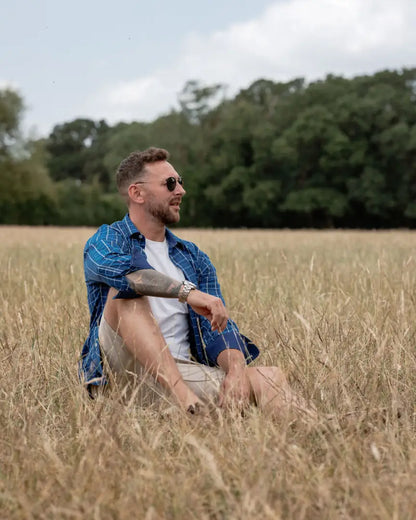 Man in a field wearing the New Forest Premium Tattersall Shirt for a forest premium look