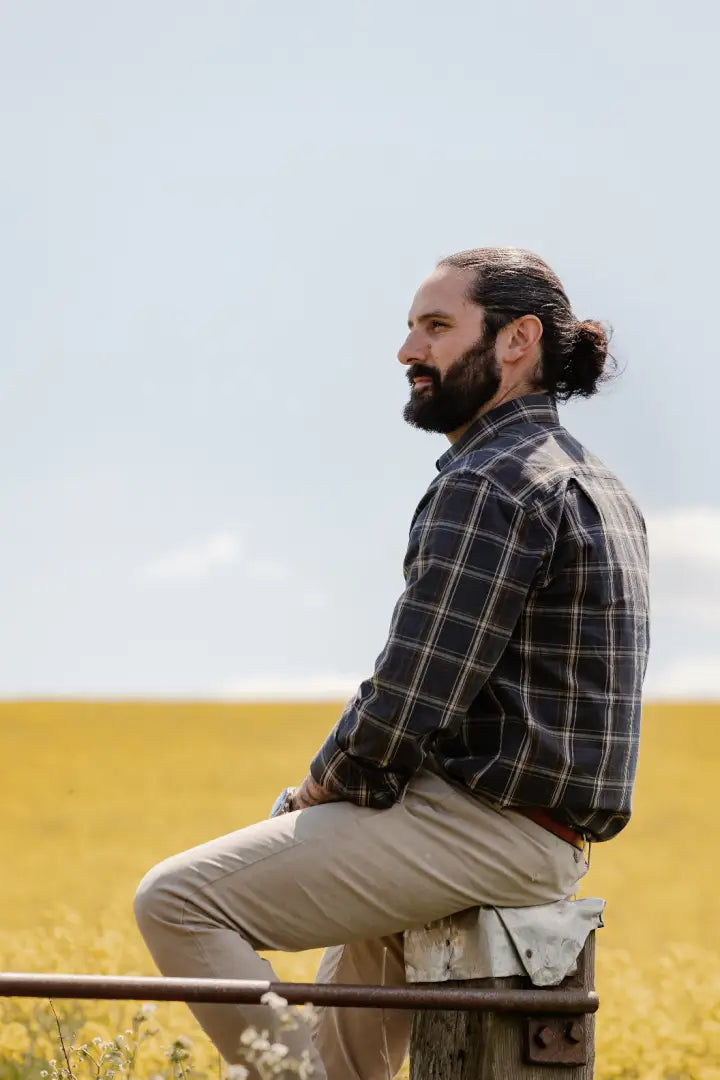 Bearded man wearing forest premium tattersall shirt in a casual setting