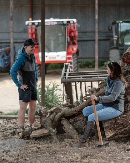 Two people with farm equipment wearing the New Forest Raptor Hoodie, perfect forest raptor gear