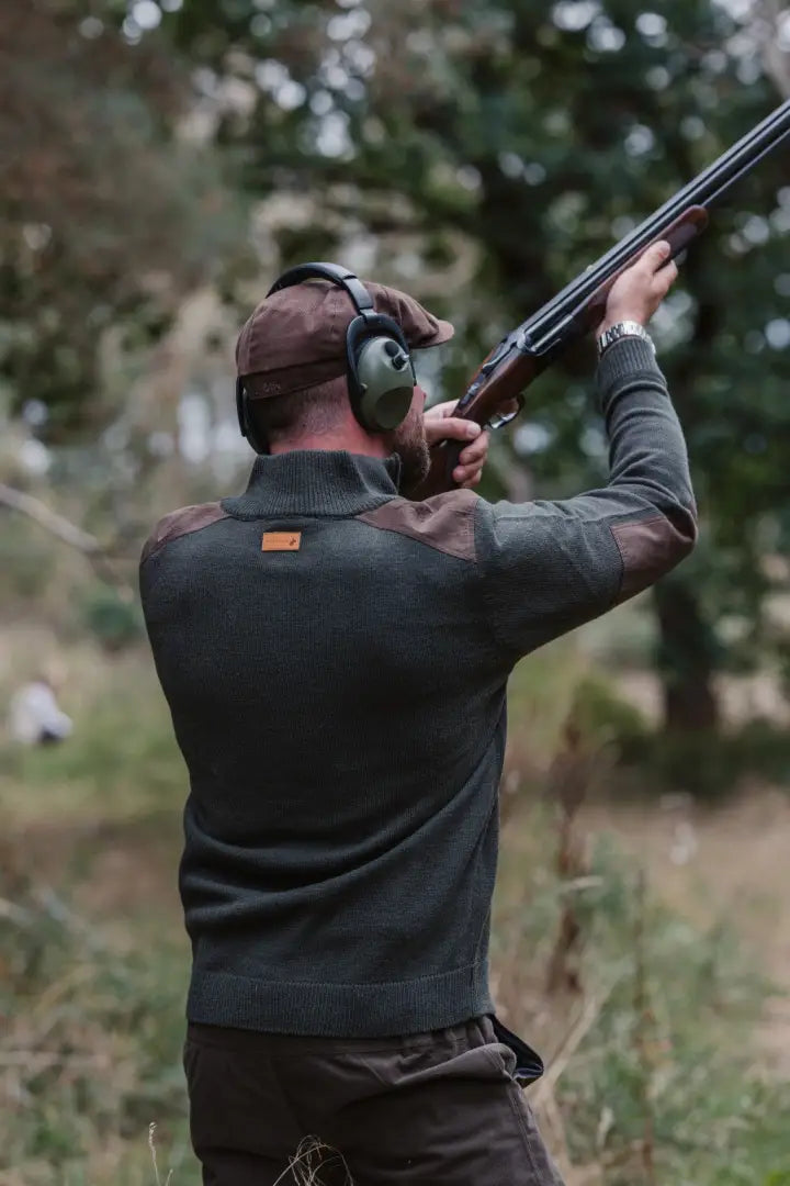 Hunter in ear protection wearing New Forest Raven Zip Neck Jumper outdoors