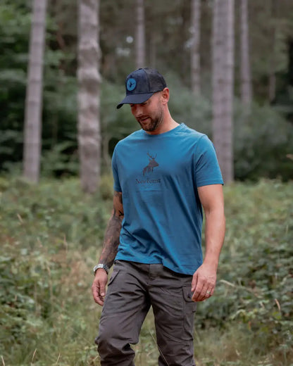 Man wearing New Forest Stag Logo T-Shirt with forest clothes graphic design