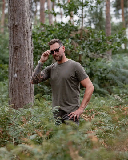 Man in green shirt and sunglasses wearing forest clothing 2-pack t-shirts