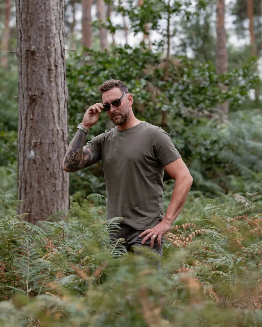 Man in green shirt and sunglasses wearing forest clothing 2-pack t-shirts